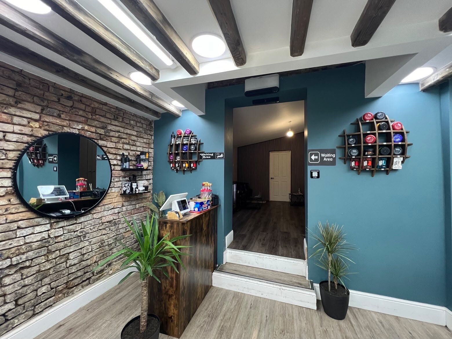 Reception desk and waiting area at Cygneture Barbers